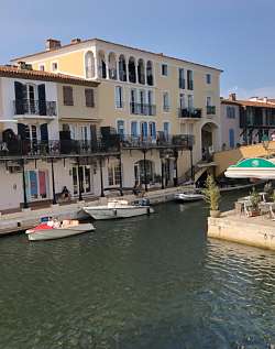 The multi-dwelling canal-side buildings and small boats capture the essence of the village.